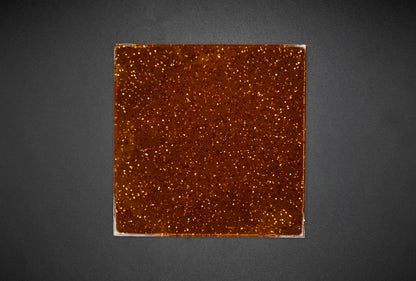 Glitter orange jelly on black background